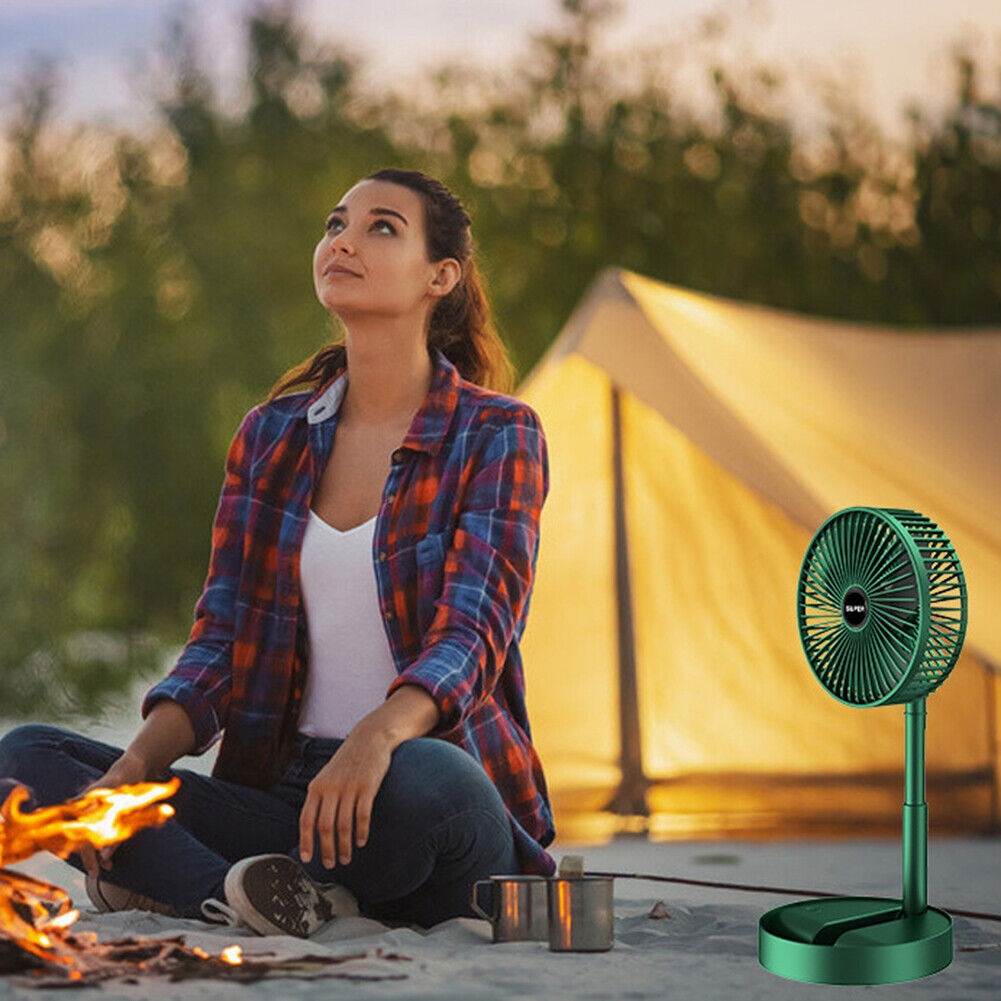 Persoană relaxându-se în camping lângă un ventilator portabil